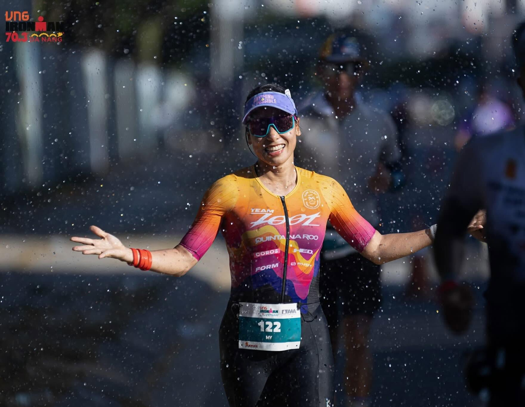 Female triathlete breaking finish tape at Nha Trang coastal race
