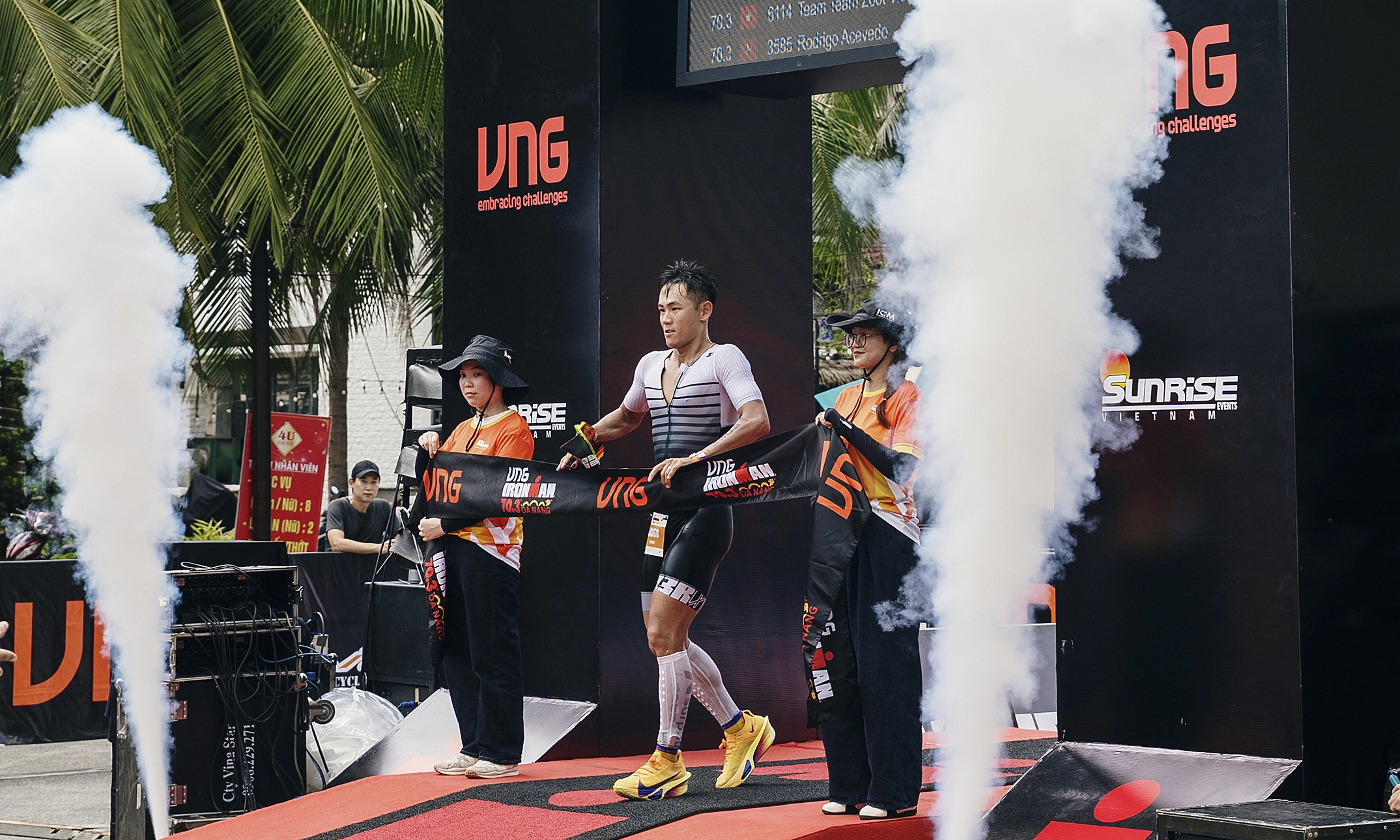 Atmospheric finish line arch with smoke effect during race day in Da Nang
